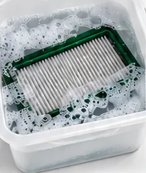 Filter soaking in a tub of soapy detergent water
