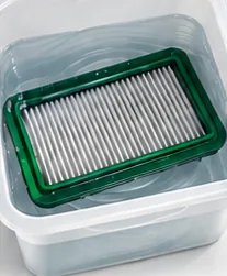 Filter soaking in a tub of clear water
